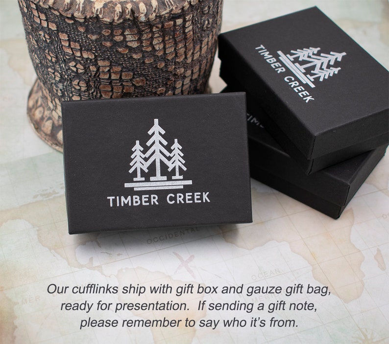 May include: Black gift box with a white logo of three stylized trees and the text "TIMBER CREEK".