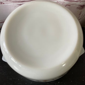 May include: White ceramic baking dish with a round bottom and a slightly flared rim. The dish is empty and appears to be new.