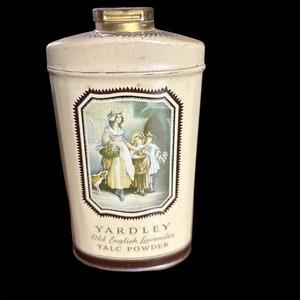 May include: A vintage Yardley Old English Lavender Talc Powder tin with a cream background and a brown and gold label. The label features a vintage illustration of a woman and two children in a garden setting.