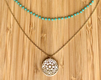 Double-row gold necklace and turquoise beads with mother-of-pearl medallion