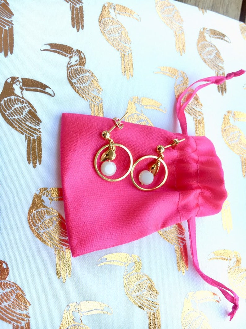 Gold earrings in fine gold small creoles with white boho glass bead with faceted