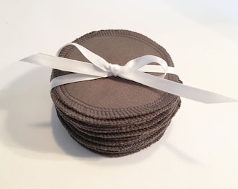 May include: A stack of gray reusable makeup remover rounds tied together with a white ribbon.