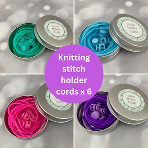 May include: Six sets of knitting stitch holders in turquoise, blue, pink, and purple. Each set includes a small tin with a label that reads "Stitch Holder Cords" and a coiled cord with stitch markers.