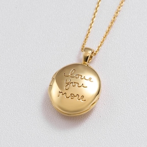 May include: Gold locket necklace with a round pendant that says "I love you more".