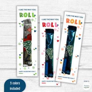 May include: Three printable Valentine's Day cards featuring a Roll-Ups candy bar with the text "I like the way you roll". The cards are in red, blue, and green.