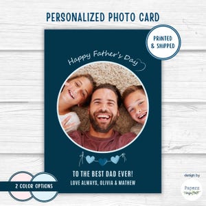 May include: A personalized photo card with a navy blue background. The card features a family photo inside a white circle, with the text "Happy Father's Day." Below the photo are three blue hearts and the message "TO THE BEST DAD EVER!"