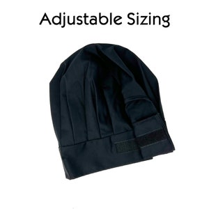 May include: Black chef hat with an adjustable strap. The hat is made of a soft, black fabric and has a classic chef hat design.