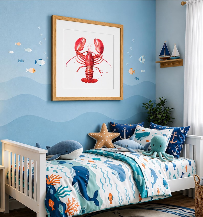 May include: A square framed wall art print featuring a vibrant red lobster illustration centered on a white background. The artwork is displayed on a light blue wall decorated with small fish decals and a wooden shelf holding two small model sailboats.