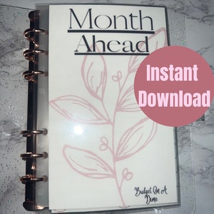 May include: A white planner with the text "Month Ahead" and a pink floral design. The planner is in a clear plastic binder with gold rings. The text "Instant Download" is on a pink circle in the upper right corner. The text "Budget On A Dime" is at the bottom of the planner.
