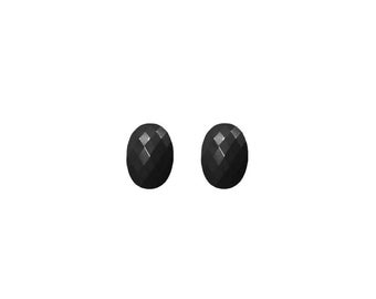 May include: A pair of black oval-shaped earrings with a faceted design.