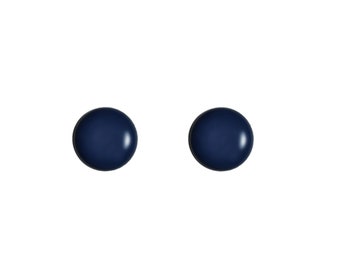 May include: Two navy blue, round stud earrings. The earrings are a solid color with a glossy finish, set against a plain white background. These simple earrings are a classic jewelry accessory.