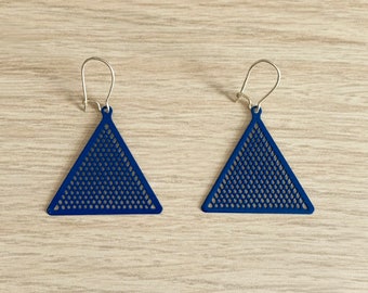 May include: A pair of blue triangle earrings with a geometric pattern. The earrings have a silver hook closure.
