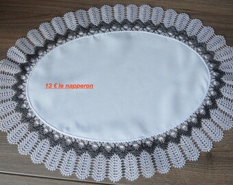 Oval lace doily made with bobbins with inlaid fabrics