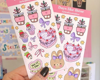 May include: Two sheets of pink sticker paper with various cute illustrations. The stickers include a heart-shaped cake with the text "days like these", a bunny with a purple bow, a cupcake with a strawberry on top, a potted plant with a pink heart, and a star. The text "Days like these" is at the top of each sheet.