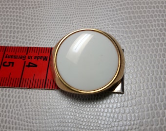 White vintage button surrounded by gold, stem at the back