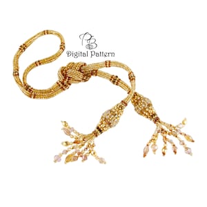 May include: A gold beaded decorative tassel with a knot in the center. The tassel features a mix of gold, brown, and clear beads. The text "Digital Pattern" is visible in the upper right corner.