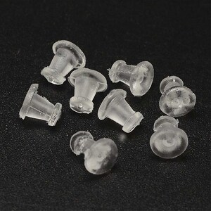 Peut inclure: Gros plan sur un groupe de dos d'oreille en plastique transparent. Les dos sont éparpillés sur une surface noire.