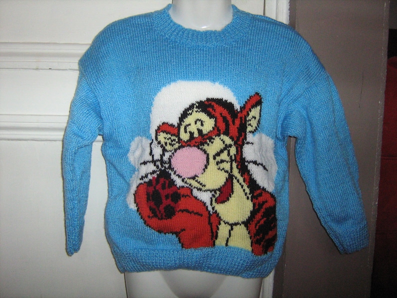 Blue jacquard sweater with hand-knitted 6-year-old tiger
