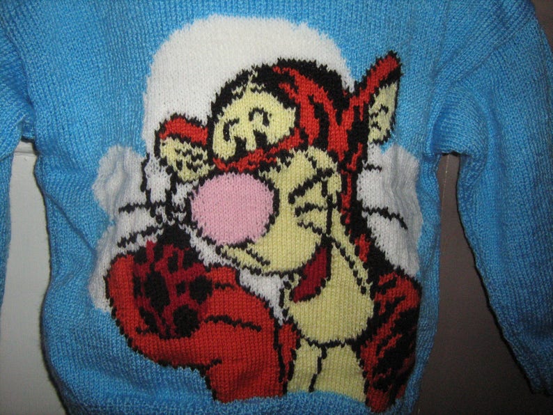Blue jacquard sweater with hand-knitted 6-year-old tiger