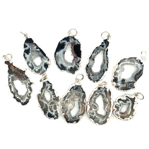 May include: Ten silver-plated agate pendants with a natural, white, and black agate pattern. Each pendant has a hole at the top for hanging.