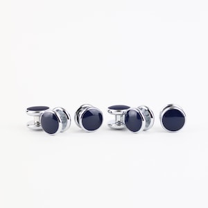May include: Set of six silver cufflinks with dark blue enamel round tops.