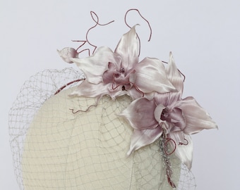 Dusty rose fascinator with birdcage veil for tropical wedding aunt of the groom