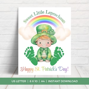 May include: A St. Patrick's Day print featuring a watercolor illustration of a baby leprechaun wearing a green hat and outfit, with a rainbow and clouds above. Green footprints flank the leprechaun. Text reads "Sweet Little Leprechaun" and "Happy St. Patrick's Day!"