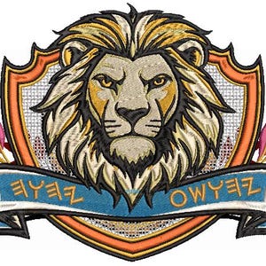 May include: An embroidered patch featuring a central lion head with a golden mane, set against a shield with orange and white borders. A blue ribbon banner sits below the lion with the text "ZEYE OWYEZ" in a stylized, angular font.