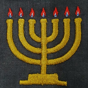 May include: A gold menorah with seven candles, each with a red and blue flame, embroidered on a black fabric background.