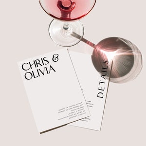 May include: Elegant wedding invitation suite with a glass of pink liquid. The invitation features the names "Chris & Olivia" in a stylish font. The word "DETAILS" is printed on a separate card. The overall design is minimalist and modern.