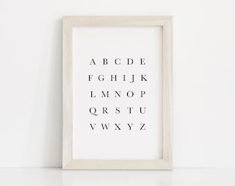 May include: A white wood frame with a white mat and a black and white alphabet print inside. The letters are in a simple font and are arranged in rows. The letters are A-Z.