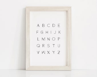 May include: A framed print with the alphabet in a minimalist font. The letters are arranged in rows, with each row containing five letters. The letters are black and the background is white.