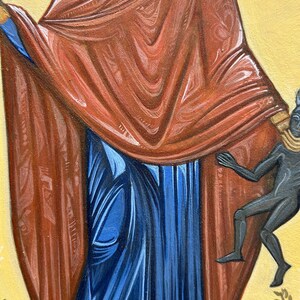 May include: A close-up of a religious icon painting depicting a figure wearing a red robe and blue dress. A small black figure is depicted at the bottom right of the image.