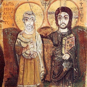 May include: An ancient religious icon featuring two figures with halos. One figure is dressed in tan robes, the other in dark robes and holding a book. The background is a faded, textured surface with Greek text.