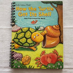 May include: A spiral-bound children's book titled "How the Turtle Got Its Shell" from the Little Golden Book series. The cover illustration features a cartoon turtle, a crab, and a large seashell. The background shows a pond and a tree.