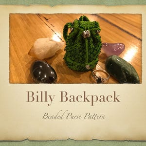 May include: A small green beaded backpack purse with silver accents and a drawstring closure. The purse is sitting on a wooden surface with several stones around it.