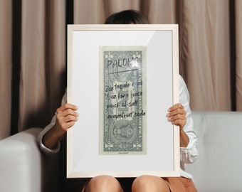 May include: A framed image of a US dollar bill with a handwritten recipe for a Paloma cocktail. The recipe includes 2 oz tequila reposado, 1 oz lime juice, a pinch of salt, and grapefruit soda.