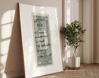 May include: A framed print featuring a dollar bill with a handwritten cocktail recipe for a Spicy Marg. The recipe includes chili pepper, coriander leaves, tequila, agave nectar, lime juice, and tajin. The frame has a gold border and is leaning against a wall.