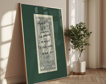 May include: A green framed poster with a US dollar bill in the center. The bill has handwritten instructions for making an Aperol Spritz: 3 oz prosecco, 1 oz Aperol, 2 oz soda water, and 1 orange slice.
