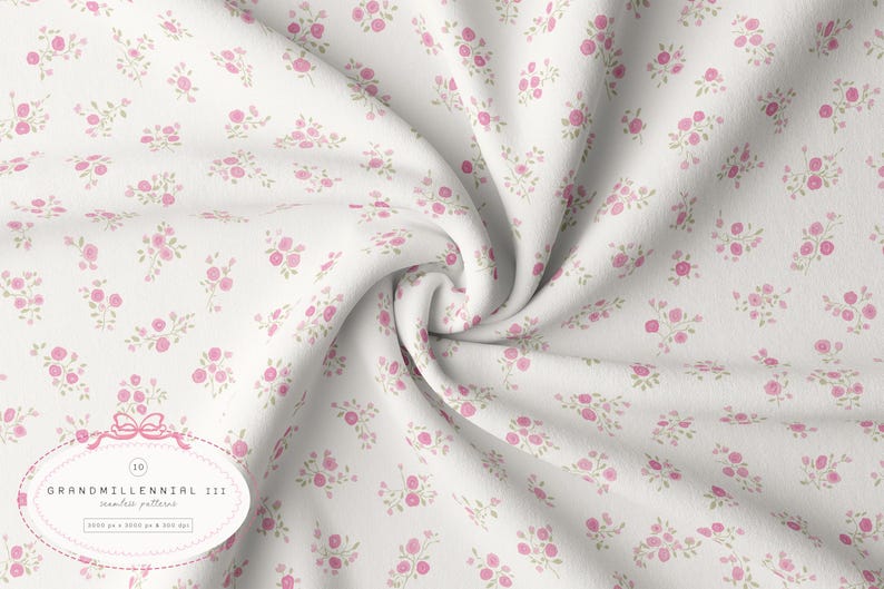 May include: White fabric featuring a delicate pattern of pink roses and green foliage. The fabric is arranged in soft folds, creating a textured appearance. The design is labelled "GRANDMILLENNIAL 111" with a bow illustration.