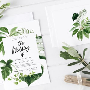 May include: A white wedding invitation with green tropical leaves and the text "the Wedding of Emily Jenkins & Jason Matterson Saturday, Eighteenth of May Two Thousand Eighteen at Three o'clock in the afternoon Manzanillo Gardens, Mexico Followed by Dinner & Dancing"