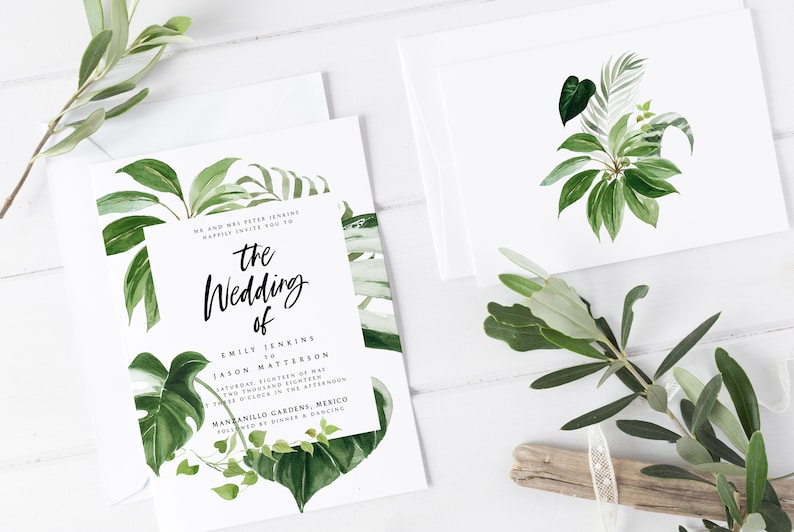 May include: A white wedding invitation with green tropical leaves and the text "the Wedding of Emily Jenkins & Jason Matterson Saturday, Eighteenth of May Two Thousand Eighteen at Three o'clock in the afternoon Manzanillo Gardens, Mexico Followed by Dinner & Dancing"