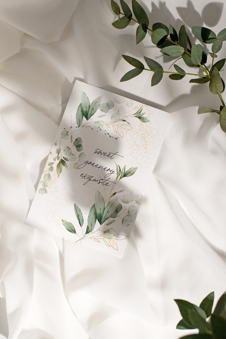 May include: A white card with a watercolor illustration of green leaves and gold accents. The text "sweet greenery exquisite" is written in black cursive on the card.