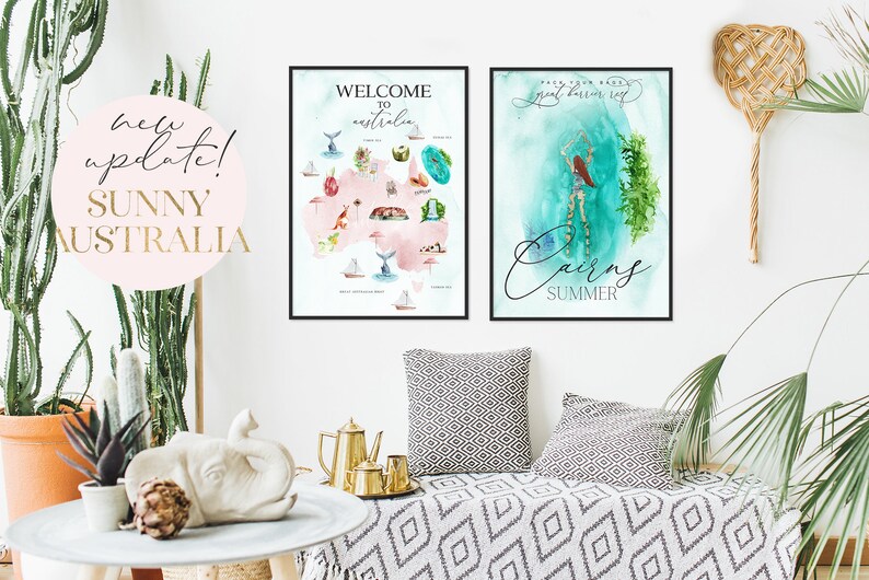 May include: Two framed watercolor prints of Australian landscapes. The first print features a map of Australia with various landmarks and the text "Welcome to Australia". The second print features a watercolor painting of a woman swimming in the ocean with the text "Cairns Summer".