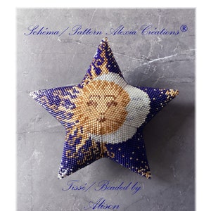 May include: A beaded star ornament with a sun and moon design in gold, white, and blue. The star is on a gray background with the text "Schema/Pattern Alexia Creations®" and "Tissée/Beaded by Alison".