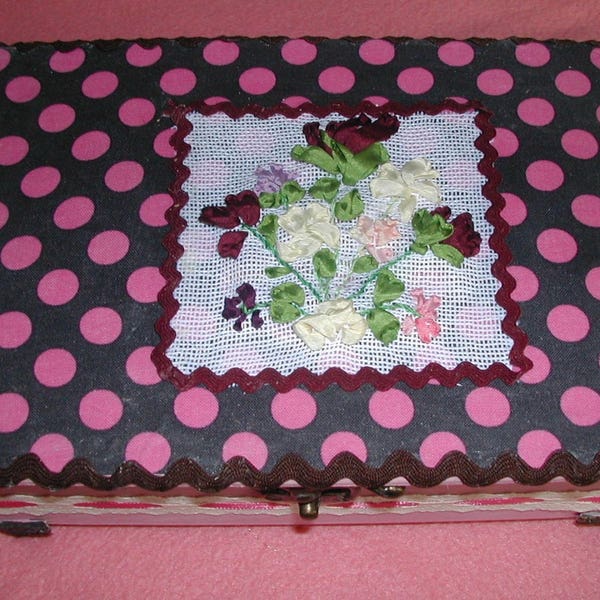 Wooden casket was dressed in fabric(tissue), black bottom with peas fushia