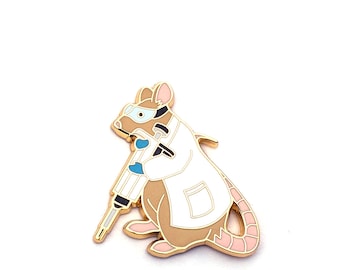May include: Gold-tone enamel pin featuring a cartoon rat wearing a white lab coat and goggles, holding a syringe.