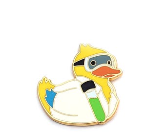 May include: A yellow rubber duck wearing a white lab coat and goggles, holding a green test tube. The duck is a science themed enamel pin.