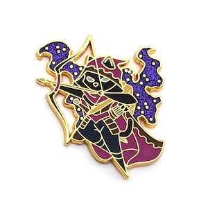 May include: Gold and purple enamel pin of a black cat dressed as a fantasy archer, holding a bow and arrow. The cat is wearing a purple and gold hooded cloak and has a purple and gold star-shaped design behind it.