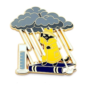 May include: A black cat wearing a yellow raincoat stands on a blue book with a gray cloud raining down on it. The cat is holding an umbrella and the book is open.